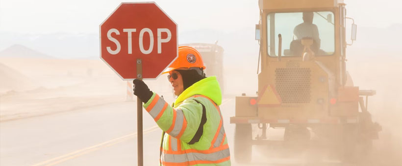 Flagger on the side of the road with stop sign