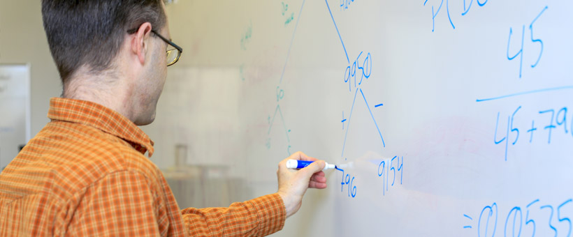 Instructor writing on a whiteboard