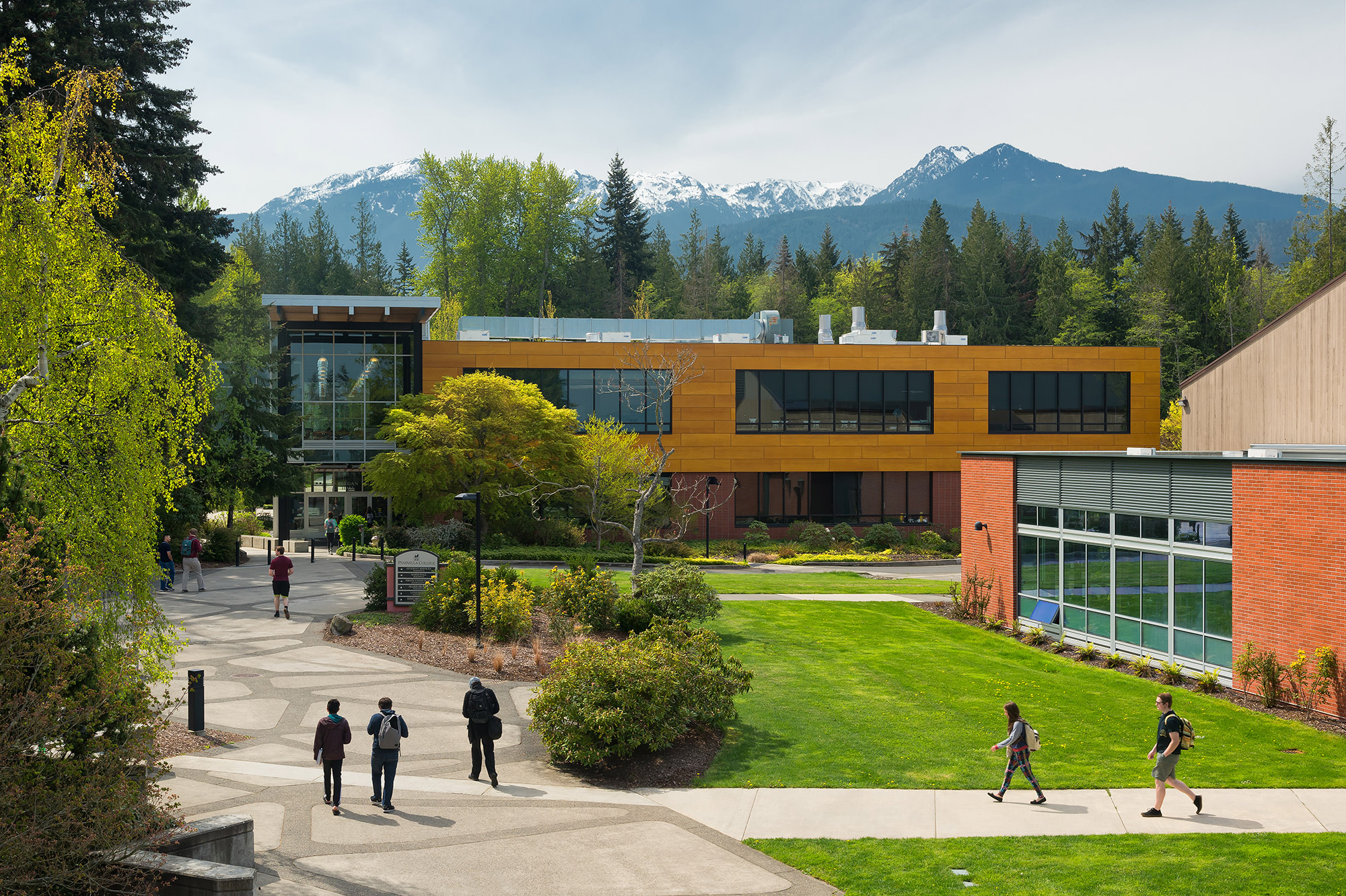 Students walking outside on campus with mountains and trees in the background