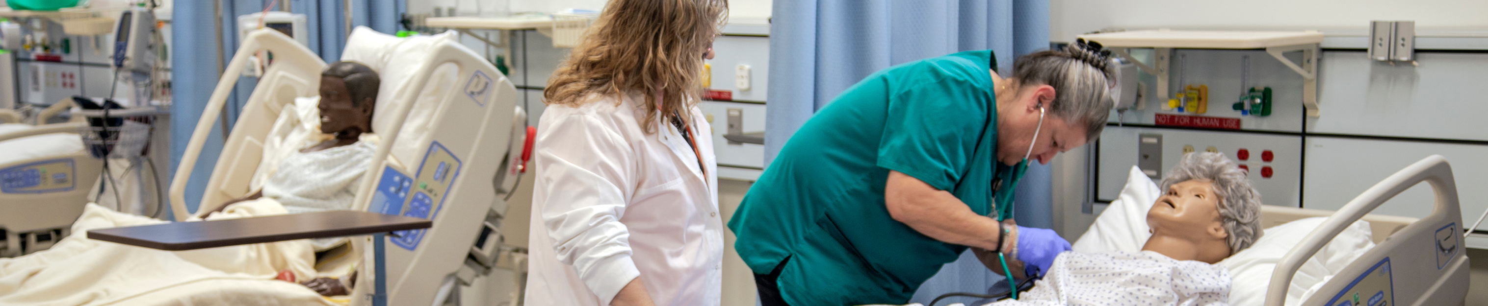 Nursing Assistant Student and Instructor in clinical class setting.