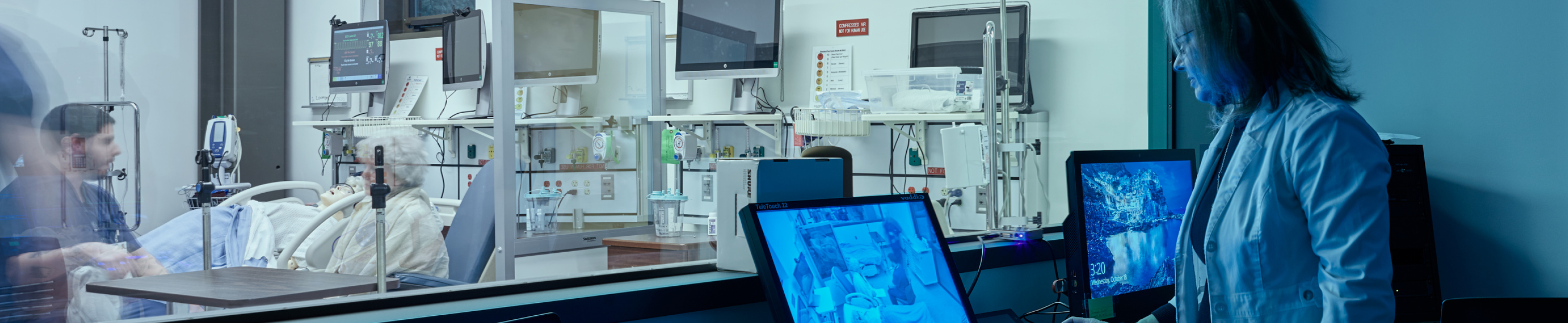 Nursing instructor watching student in clinical setting.