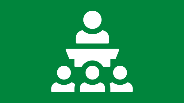 Instructor speaking in front of three students