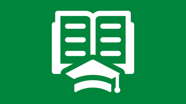 Graduation cap in front of an open book