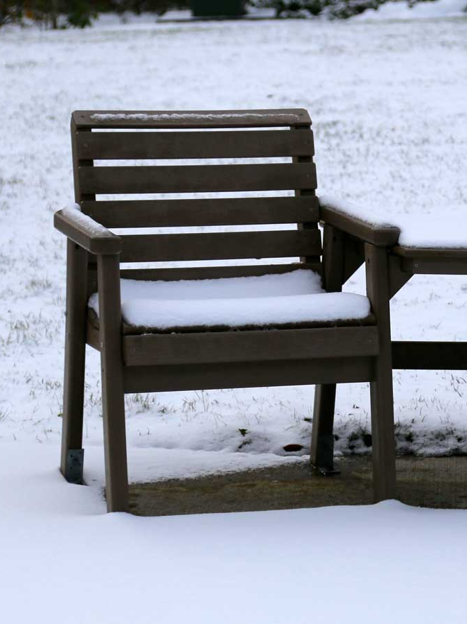 two chairs covered in snow
