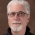 closeup of man with white hair and glasses